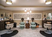 Thumbnail 3 of 5 - A salon with chairs and mirrors on the wall.
