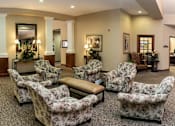 Thumbnail 3 of 4 - A room with floral chairs at Hearthside Collierville, Collierville, TN.