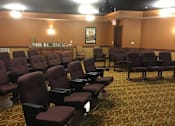 Thumbnail 3 of 5 - Theatre with rows of brown seats in a room at The Shores of Lake Phalen, Maplewood, MN.