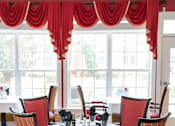 Thumbnail 3 of 5 - Dining room table with red chairs and windows Spring Arbor of Cary, Cary