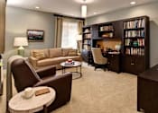 Thumbnail 2 of 5 - A living room with a library and a couch at The Piper, Kansas City, KS. 