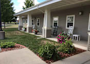Thumbnail 2 of 6 - A small house with a porch at Windsor Manor Vinton, Vinton, IA