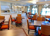 Thumbnail 4 of 5 - A dining room with wooden chairs and tables at Waterstone on Augusta, Greenville, SC