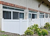 Thumbnail 30 of 35 - Private patio with white vinyl fence and landscaping at Fox Run Apartments, St. Charles, Illinois