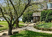 Thumbnail 34 of 35 - Curved walkway leading to building entrance with landscaping at Fox Run Apartments, Illinois, 60174