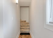 Thumbnail 7 of 35 - Carpeted staircase leading to upper level hallway at Fox Run Apartments, St. Charles, 60174