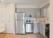 Thumbnail 7 of 28 - a kitchen with stainless steel appliances and white cabinets at Aspen Ridge Apartments, West Chicago