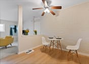 Thumbnail 4 of 28 - a dining room with a table and chairs and a ceiling fan at Aspen Ridge Apartments, West Chicago, IL