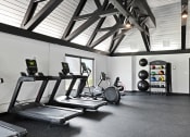 Thumbnail 18 of 28 - a gym with treadmills and other exercise equipment in a building  at Aspen Ridge Apartments, West Chicago, IL, 60185