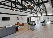 Thumbnail 19 of 28 - a large living room with high ceilings and a table with chairs at Aspen Ridge Apartments, West Chicago