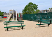 Thumbnail 26 of 28 - a playground with a slide and benches in a park at Aspen Ridge Apartments, West Chicago, 60185
