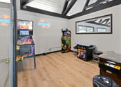 Thumbnail 12 of 28 - a game room with arcade games and video games at Aspen Ridge Apartments, Illinois