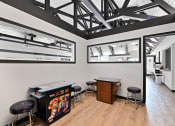 Thumbnail 11 of 28 - a room with two tables and two windows and a projector screen on the wall at Aspen Ridge Apartments, Illinois