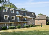 Thumbnail 28 of 28 - a brick apartment building with balconies and a lawn at Aspen Ridge Apartments, West Chicago, Illinois