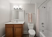 Thumbnail 11 of 35 - Bathroom with white subway tile and wood vanity at Fox Run Apartments, St. Charles