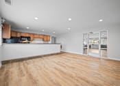 Thumbnail 22 of 35 - Open living space with kitchen and glass patio doors at Fox Run Apartments, Illinois