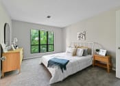 Thumbnail 6 of 35 - a bedroom with a bed and a dresser at Waldan Pond Apartments, Georgia, 30102
