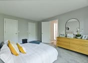 Thumbnail 7 of 35 - a bedroom with a large bed and a dresser with a mirror at Waldan Pond Apartments, Acworth, GA, 30102