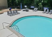 Thumbnail 30 of 35 - a swimming pool with chairs and a fence around it