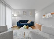 Thumbnail 11 of 35 - a living room with a blue couch and a white coffee table