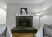 Thumbnail 4 of 35 - a living room with a fireplace and a couch