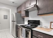 Thumbnail 1 of 35 - a kitchen with stainless steel appliances and a refrigerator