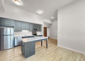 Thumbnail 12 of 24 - an open kitchen with stainless steel appliances and a counter top