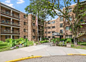 Thumbnail 18 of 25 - an apartment building with an flag in the courtyard