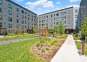 Thumbnail 53 of 53 - the courtyard of an apartment building with grass and trees