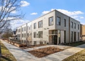 Thumbnail 23 of 45 - the exterior of a three story apartment building with a sidewalk