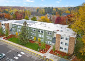 Thumbnail 16 of 25 - an aerial view of a building with a parking lot and trees