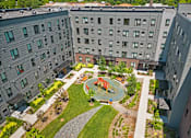 Thumbnail 48 of 53 - an aerial view of the courtyard of an apartment building with a playground