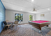 Thumbnail 18 of 23 - a game room with a pool table and a dining table