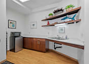 Thumbnail 26 of 27 - a kitchen with a sink and a refrigerator