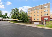 Thumbnail 24 of 35 - an apartment building with a street in front of it
