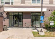 Thumbnail 50 of 52 - a sidewalk in front of a building with glass doors