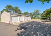 Thumbnail 17 of 27 - a parking lot with a row of garages on the side of a building