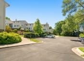 Thumbnail 46 of 57 - the view of an apartment complex with a car parked on the street
