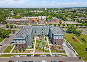 Thumbnail 47 of 53 - an aerial view of a building in the middle of a parking lot