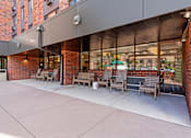 Thumbnail 8 of 55 - a patio with benches and tables outside of a building