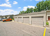 Thumbnail 30 of 41 - a garage with a car parked in front of it