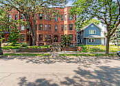 Thumbnail 44 of 67 - a red brick building with trees in front of it