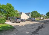 Thumbnail 19 of 27 - a parking lot with cars parked in front of houses