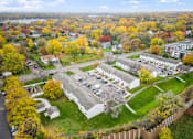 Thumbnail 6 of 23 - A view of a campus with a mix of trees and buildings.