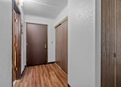 Thumbnail 9 of 23 - the entrance to a room with wooden floors and a door