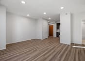 Thumbnail 18 of 45 - a living room with white walls and wood floors