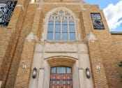 Thumbnail 41 of 45 - the front of a church with stairs and a brown door