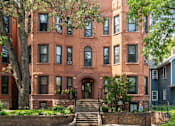 Thumbnail 42 of 67 - a brick building with stairs and trees in front of it
