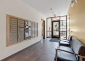 Thumbnail 48 of 52 - the lobby of a building with chairs and a bulletin board on the wall