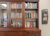 Thumbnail 31 of 51 - a bookshelf filled with books in a room